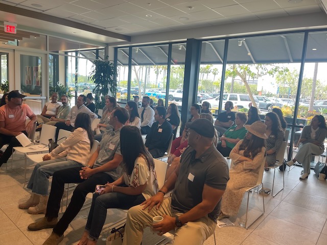 A group of professionals engaged in a mindfulness workshop during a 90-day corporate wellness session.